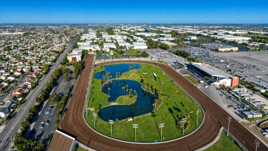 Aerial view of the Los Alamitos Race Track in Cypress, CA, with the grandstand, infield lakes, and Katella Avenue